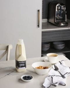 Bowl of cereal with coffee, barista milk and blueberries