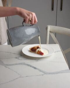 Double cream being poured on a tart