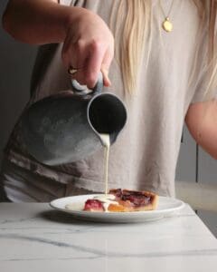 Woman pouring cream on a pie